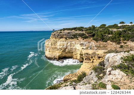 Portuguese coast in Benagil, Algarve, Portugal. Alfanzina Lighthouse. Seven Hangging Valleys Trail. 128426344