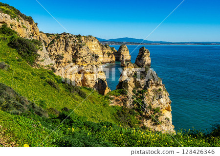 Ponta da Piedade is a unique rock formation with famous grottos in the ocean at Lagos, Algrave, Portugal 128426346