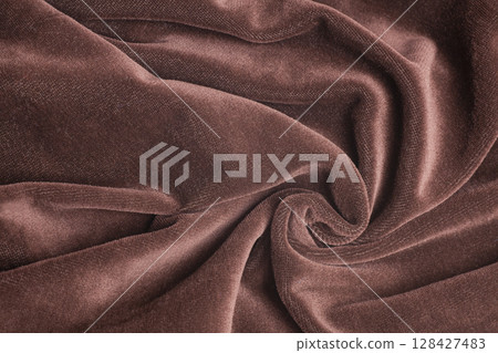 Brown velvet fabric with spiral folds Brown velvet fabric with spiral folds 128427483