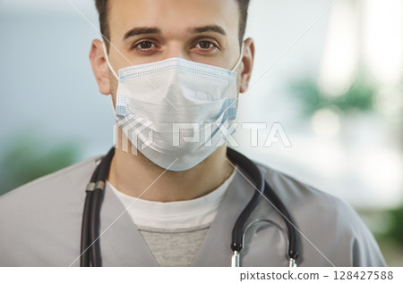 Physician, surgeon, assistant doctor, serious male nurse medical professional, wearing face mask Physician, surgeon, assistant doctor, serious male nurse medical professional, wearing face mask 128427588