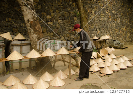 Man making hats. 128427715