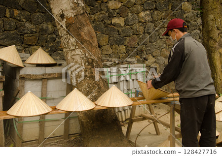 Man making hats. Man making hats. 128427716