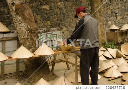 Man making hats. 128427718