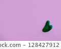 Jade massager on a pink background. Background with copy space. 128427912
