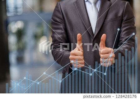 Businessman signals finance success Businessman signals finance success 128428176