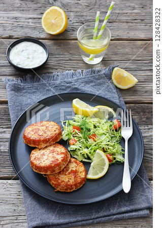 Hot Smoked salmon burgers, patties and coleslaw 128428322