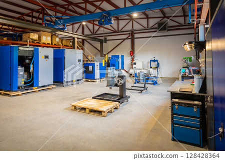 Industrial compressors and equipment in a warehouse setting 128428364