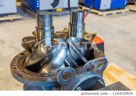 Shiny new screw compressor rotors showing engineering precision Shiny new screw compressor rotors showing engineering precision 128428404