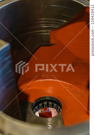 Inside view of industrial gearbox showing gears and bearings 128428412