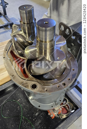 Shiny screw compressor rotors showing engineering precision Shiny screw compressor rotors showing engineering precision 128428420