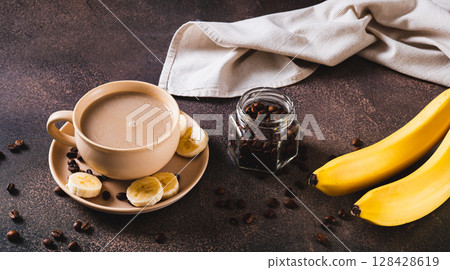 Alternative cold banana coffee in a cup on the table web banner Alternative cold banana coffee in a cup on the table web banner 128428619