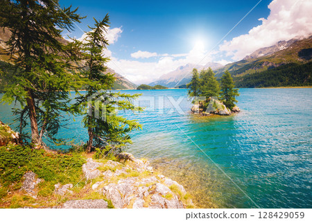 Great view on azure lake Silsersee (Sils) and peak Piz Corvatsch in the Swiss alps. Location Upper Engadine valley, Europe. 128429059