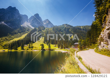 Alpine lake Vorderer Gosausee. Salzkammergut is a famous resort area located in the Gosau Valley in Upper Austria. Dachstein glacier. Alpine lake Vorderer Gosausee. Salzkammergut is a famous resort area located in the Gosau Valley in Upper Austria. Dachstein glacier. 128429121