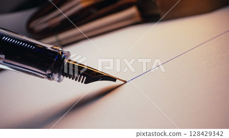 Macro Of Fountain Pen Nib Writing Straight Ink Line On Textured Paper Surface Macro Of Fountain Pen Nib Writing Straight Ink Line On Textured Paper Surface 128429342