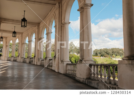 Elegant arched colonnade at Sanctuary of Fatima Portugal with stone columns classic lanterns and scenic view sacred peaceful walkway around historic Catholic pilgrimage site. High quality photo Elegant arched colonnade at Sanctuary of Fatima Portugal with stone columns classic lanterns and scenic view sacred peaceful walkway around historic Catholic pilgrimage site. High quality photo 128430314