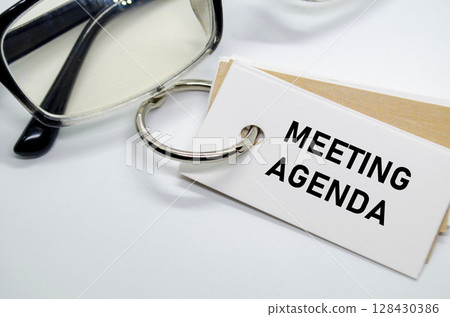 Meeting Agenda with keyring on white notepad. Meeting Agenda with keyring on white notepad. 128430386