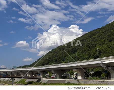 Hanshin Expressway and cumulonimbus clouds passing through the foot of Satsukiyama Hanshin Expressway and cumulonimbus clouds passing through the foot of Satsukiyama 128430769