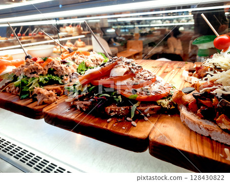 Colorful Open Sandwiches with Fresh Toppings Displayed in Restaurant Showcase 128430822
