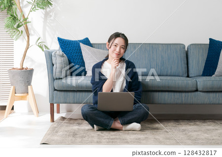 Young woman relaxing in the living room Young woman relaxing in the living room 128432817