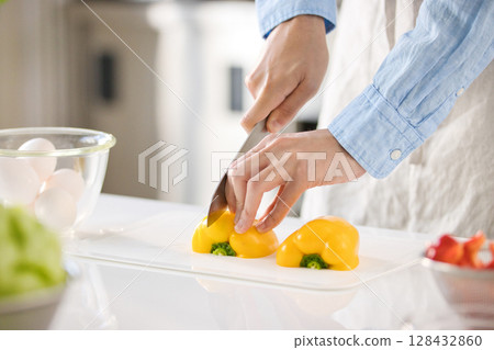 Hands of a young man cutting vegetables 128432860