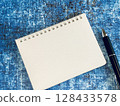 Blank notebook and pen (blue background) 128433578
