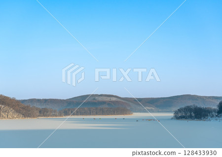 Abashiri City, Hokkaido: Lake Abashiri on a frozen morning and a tent for smelt fishing Abashiri City, Hokkaido: Lake Abashiri on a frozen morning and a tent for smelt fishing 128433930