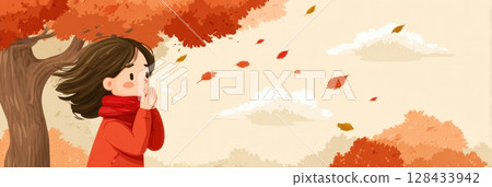 A girl wearing a red scarf sneezes playfully under a vibrant autumn tree as leaves swirl around her in a colorful display of fall. 128433942