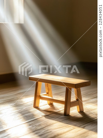 wooden bench illuminated by soft morning light in serene room creates peaceful atmosphere. gentle rays enhance natural beauty of wood wooden bench illuminated by soft morning light in serene room creates peaceful atmosphere. gentle rays enhance natural beauty of wood 128434051