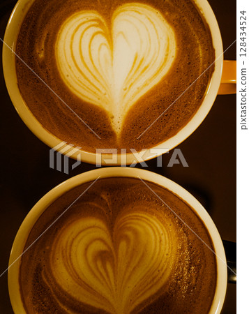 Cups of coffee decorated with a heart 128434524