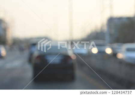 highway traffic with safety barrier on road asphalt, blurred image 128434737