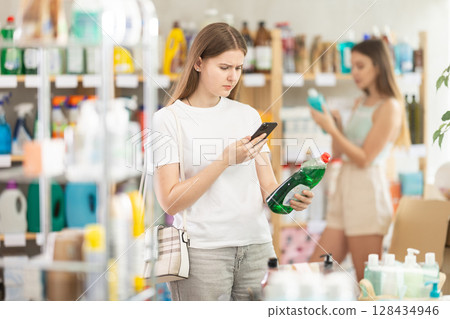 Young woman scanning qr code for dishwashing Young woman scanning qr code for dishwashing 128434946