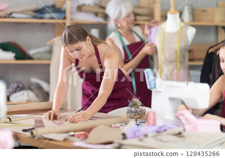 team of female seamstresses works in the atelier team of female seamstresses works in the atelier 128435266