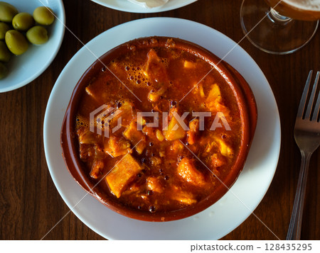 Portion of stewed tripe is cooked in plate - stomach of cattle 128435295
