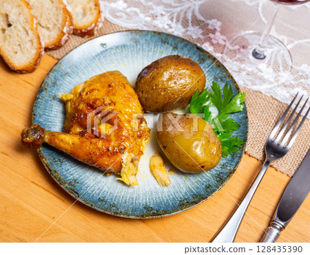 Chicken served with potatoes on platter 128435390