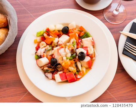 Seafood and vegetable salad served on platter Seafood and vegetable salad served on platter 128435470