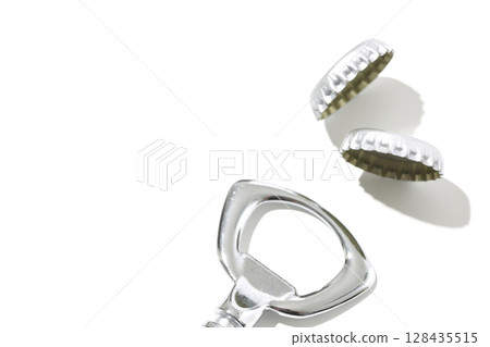 Bottle opener and crown on white background Bottle opener and crown on white background 128435515