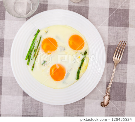 Homemade healthy breakfast: fried eggs and asparagus closeup 128435524