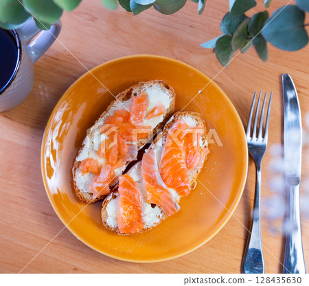 Sandwich with salmon served on platter Sandwich with salmon served on platter 128435630