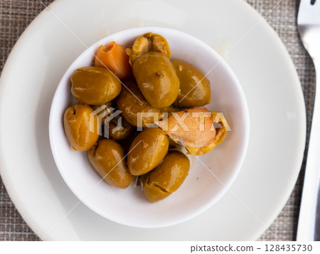 Light snack - few of pickled green pitted olives and slice of bran bread Light snack - few of pickled green pitted olives and slice of bran bread 128435730