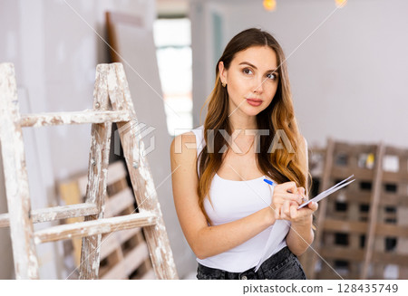 Woman construction manager checking project documentation Woman construction manager checking project documentation 128435749