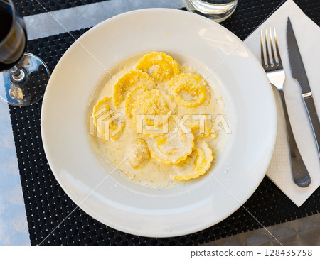 Italian ravioli pasta served with cheese 128435758