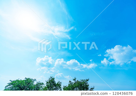 Blue sky, clouds, sun and trees 128436076