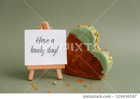 HAVE A LOVELY DAY text caption card Delicious fresh croissant topped with Matcha Green Tea flavor Ganache. Creation unique heart shape bakery. Puff pastry holiday love gift present idea Valentine's 128436597