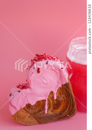 Pink drink Matcha beverage dragon fruit powder superfood Heart shaped cherry flavor croissant on pink background with copy space. Puff pastry new trendy sweet dessert bakery. Creamy dough 128436616