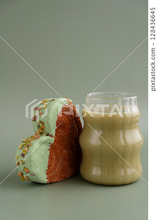 Nutrient-rich matcha drink with Green latte Matcha tea coffee with Delightful and vibrant heartshaped pastry croissant treat, beautifully topped with colorful frosting nut galore. Mock up template 128436645