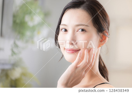 Beauty skin care. Close-up of beautiful woman with natural skin, looking at camera. Spring/summer-like image. Beauty skin care. Close-up of beautiful woman with natural skin, looking at camera. Spring/summer-like image. 128438349