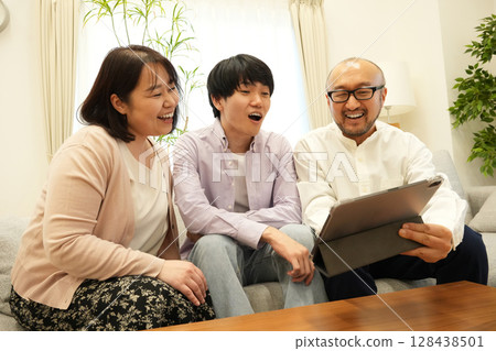Family looking at tablet Family looking at tablet 128438501