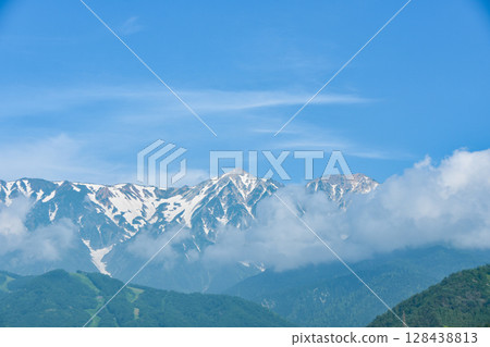 Early summer scenery in Shinshu: Snow still remaining on the Hakuba Sanzan mountains Early summer scenery in Shinshu: Snow still remaining on the Hakuba Sanzan mountains 128438813