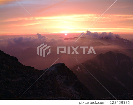 Mt. Yari / Midsummer sunset over the Nishikama Ridge as seen from Mt. Yari in midsummer (Summer mountain climbing, Yari-Hotaka traverse) Mt. Yari / Midsummer sunset over the Nishikama Ridge as seen from Mt. Yari in midsummer (Summer mountain climbing, Yari-Hotaka traverse) 128439585