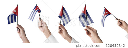 The Cuba flag in hand in different angles on a white background The Cuba flag in hand in different angles on a white background 128439842